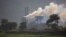 FILE- Smoke rises from a coal-powered steel plant at Hehal village near Ranchi, India, in eastern state of Jharkhand, Sept. 26, 2021.