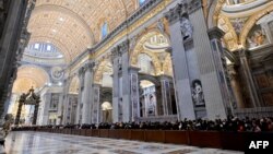 Faithful queue up to pay respect at the body of Pope Emeritus Benedict XVI at St. Peter's Basilica in the Vatican, Jan. 2, 2023. 