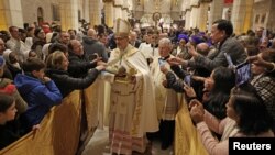 The Archbishop Pierbattista Pizzaballa, apostolic administrator of the Latin Patriarch of Jerusalem leads a Christmas midnight mass at Saint Catherine's Church, in the Church of the Nativity in Bethlehem, Dec. 25, 2022.