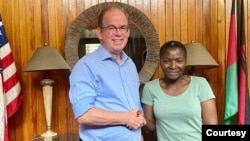 FILE - Martha Chizuma poses with Ambassador David Young hours after her arrest, Dec. 6, 2022. (Photo courtesy of the American Embassy in Malawi)