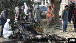 Policemen collect evidence at the suicide blast site in Islamabad on Dec. 23, 2022.