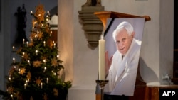 A photograph of the late former Pope Emeritus Benedict XVI is seen during a prayer in the Cathedral Church of Our Lady (Frauenkirche), Dec. 31, 2022, in Munich, Germany.