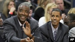 FILE - Charlotte Bobcats coach Paul Silas and his son and assistant coach Stephen Silas at an NBA basketball game in Charlotte, N.C., Jan. 8, 2011.