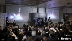 Officials of ispace Inc's HAKUTO-R mission look at live broadcasting of the launch of a SpaceX Falcon 9 rocket for ispace at Cape Canaveral Space Force Station, in Tokyo, Dec. 11, 2022. (Kyodo via Reuters)