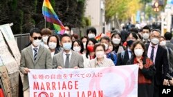 Plaintiffs and supporters walk to the Tokyo district court in Tokyo, Japan, on Nov. 30, 2022, the same day that Japan's lack of law to protect the right of same-sex couples to marry and become families was ruled unconstitutional by the Tokyo District Court.