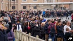 People line up to enter Saint Peter's Basilica at the Vatican where late Pope Benedict 16 is being laid in state at The Vatican, Jan. 2, 2023.