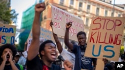 FILE - People shout slogans during a protest over the deaths of at least 23 people at the border between the Spanish enclave of Melilla and Morocco grow at Callao square in Madrid, Spain, July 1, 2022.