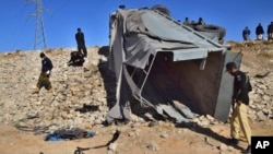 FILE - Pakistani security officials inspect a damaged truck at the site of suicide bombing on the outskirts of Quetta, Pakistan, Nov. 30, 2022. The outlawed Tehrik-i-Taliban Pakistan, also known as the Pakistani Taliban, claimed responsibility for the attack.