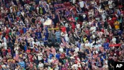 Fans from the United States cheer for their team during the World Cup group B soccer match between England and The United States, at the Al Bayt Stadium in Al Khor, Qatar, Friday, Nov. 25, 2022.