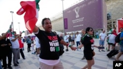Protesters wear T-shirts reading 'Rise with the women of Iran' outside the Ahmad Bin Ali Stadium at the end of the World Cup group B soccer match between Wales and Iran, in Al Rayyan, Qatar, Nov. 25, 2022.
