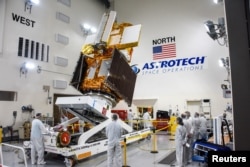 The Surface Water and Ocean Topography (SWOT) radar satellite spacecraft is moved into a transport container inside the Astrotech facility at Vandenberg Space Force Base in California, U.S. November 18, 2022. USSF/Chris Okula/Handout via REUTERS.