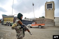 FILE - A Taliban security personnel stands guard at the Afghanistan-Pakistan border in Spin Boldak, Dec. 12, 2022.
