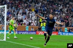 France's Kylian Mbappe celebrates after scoring his third goal against Argentina during the World Cup final soccer match at the Lusail Stadium in Lusail, Qatar, Sunday, Dec. 18, 2022. (AP Photo/Natacha Pisarenko)