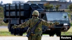 FILE - A member of the Japan Ground Self-Defense Force (JGSDF) conducts a military drill with an anti-ship missiles unit, at JGSDF Miyako camp on Miyako Island, Okinawa prefecture, Japan, Apr. 21, 2022. 