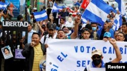 FILE - Nicaraguans exiled in Costa Rica march in a protest against Nicaragua's municipal elections, in San Jose, Costa Rica, Nov. 6, 2022.