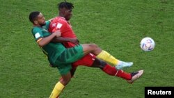 Switzerland's Breel Embolo fights for the ball with Cameroon's Jean-Charles Castelletto during the World Cup group G soccer match at the Al Janoub Stadium in Al Wakrah, Qatar, Nov. 24, 2022.
