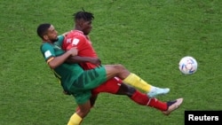 Switzerland's Breel Embolo fights for the ball with Cameroon's Jean-Charles Castelletto during the World Cup group G soccer match at the Al Janoub Stadium in Al Wakrah, Qatar, Nov. 24, 2022.