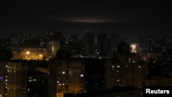 A fireball from an explosion is seen above Kyiv's skyline during Russian drone strikes, on Ukraine's capital, Jan. 1, 2023. 