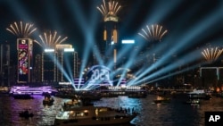FILE - Fireworks are seen over Victoria Harbour at midnight on New Years Sunday Jan. 1, 2023 in Hong Kong. (AP Photo/Anthony Kwan)