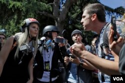 Demonstrators sharing opposing views argue during a rally Thursday, April 27, 2017, in Berkeley, Calif. Demonstrators gathered near the University of California, Berkeley campus amid a strong police presence and rallied to show support for free speech and condemn the views of Ann Coulter and her supporters. (AP Photo/Marcio Jose Sanchez)