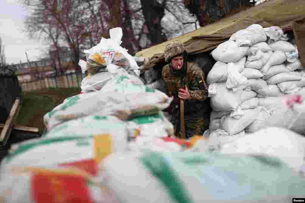 A Ukrainian military personnel is seen at a checkpoint near a train track in Odessa, March 14, 2022.
