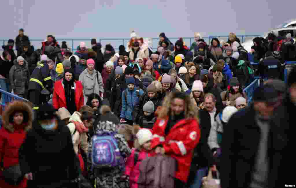 People arrive by ferry after fleeing from Russia&#39;s invasion of Ukraine, at the Isaccea-Orlivka border crossing, Romania, March 14, 2022.