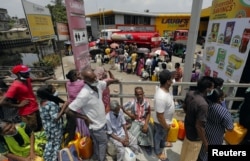 People stand in a long queue to buy kerosene oil for kerosene cookers amid a shortage of domestic gas due to country's economic crisis, at a fuel station in Colombo, Sri Lanka, March 21, 2022.