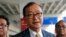 FILE - Cambodia's exiled opposition leader Sam Rainsy talks to the media upon arrival at Soekarno-Hatta International Airport in Tangerang, Indonesia on Nov. 14, 2019. 