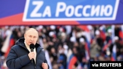 Russian President Vladimir Putin delivers a speech during a rally at Luzhniki Stadium in Moscow, March 18, 2022. The banner reads: "For Russia," using the untraditional "Z" representative of Russia's campaign in Ukraine. (Sputnik/Kremlin via Reuters)