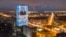 FILE - An electronic screen, installed on the facade of a business tower, shows an image of Russian President Vladimir Putin speaking during his annual state of the nation address, in St. Petersburg, Russia, April 21, 2021.
