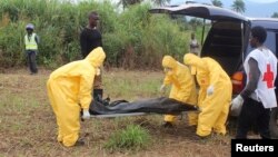 FILE - Health workers carry the body of an Ebola virus victim in the Waterloo district of Freetown, Sierra Leone. 
