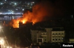 Smoke rises from the Guest House building in Basra, Iraq, Sept. 6, 2018.