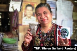 Local chieftain Baby Jerlina Owok poses for a photo with coffee beans grown by her community in Mindanao, the Philippines, March 26, 2018.