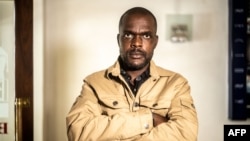 FILE - Freelance journalist for the New York Times, Jeffery Moyo, poses for a photograph after his release from detention at the Bulawayo prison in Bulawayo, Zimbabwe, June 16, 2021.