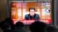 People watch a TV showing a file image of North Korean leader Kim Jong Un shown during a news program at the Seoul Railway Station in Seoul, South Korea, Thursday, Jan. 20, 2022. (AP Photo/Ahn Young-joon)