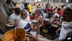 FILE - Tigrayans queue to receive food donated by local residents at a reception center for the internally displaced, in Mekele, in Ethiopia's Tigray region, May 9, 2021. 
