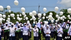 Students hold white balloons during a demonstration against violence, after recent incidents between Thai rangers and suspected separatists, in Ra-ngae district in the southern Thai province of Narathiwat, March 21, 2022.