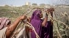 Somali women who fled drought-stricken areas start to build shelters at a makeshift camp on the outskirts of the capital Mogadishu, Somalia, Feb. 4, 2022.