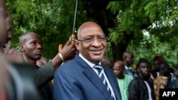 FILE - Then-Prime Minister Soumeylou Boubeye Maiga stands outside a polling station in Bamako, Aug. 12, 2018.