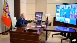 Russian President Vladimir Putin chairs a Security Council meeting via videoconference at the Novo-Ogaryovo residence outside Moscow, Russia, Thursday, March 3, 2022. (Sputnik via AP)