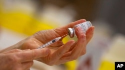 FILE - Moderna and vaccine promoter Gavi have announced, May 3, 2021, the pharmaceutical company will provide up to 500 million coronavirus vaccine doses for the U.N.-backed program for needy people in low- and middle-income countries by the end of 2022.