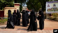 Indian Muslim students wearing burqas leave Mahatma Gandhi Memorial college after they were denied entry into the campus in Udupi, Karnataka state, India, Feb. 24, 2022. (AP Photo/Aijaz Rahi)