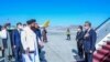 Menteri Luar Negeri Taliban Amir Khan Muttaqi (kiri) menyambut kedatangan Menteri Luar Negeri China Wang Yi (kanan) ketika Wang tiba di Bandara Kabul, pada 24 Maret 2022. (Foto: Taliban Foreign Ministry/AFP)