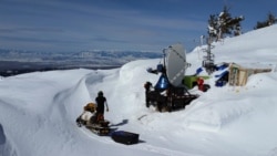 A researcher travels by snowmobile around the research site of the SNOWIE project in western Idaho. (Photo Credit: Joshua Aikins)