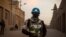 FILE - Policemen of the United Nations Stabilization Mission in Mali (MINUSMA) patrol in front on the Great Mosque in Timbuktu, Mali, Dec. 8, 2021.