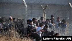 FILE - Syrian refugees cross into Turkey after breaking the border barrier on June 14, 2015. (AP Photo/Lefteris Pitarakis, File)