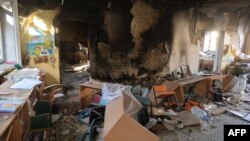 FILE - A classroom is littered with debris at a school hit by a Russian air bomb in Kharkiv, Ukraine, March 23, 2022.