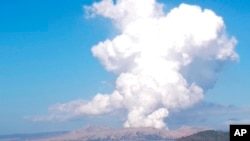 Taal volcano spews white steam and ash as seen from Balete, Batangas province, south of Manila, Philippines, on March 26, 2022.