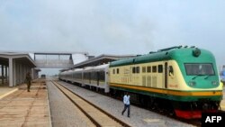 FILE - A man walks past a train of the newly completed Abuja-Kaduna railway line in Abuja, July 21, 2016.