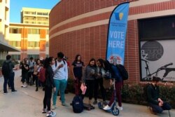 FILE - Young voters wait on line at a polling station at the University of Southern California, in Los Angeles, March 3, 2020.